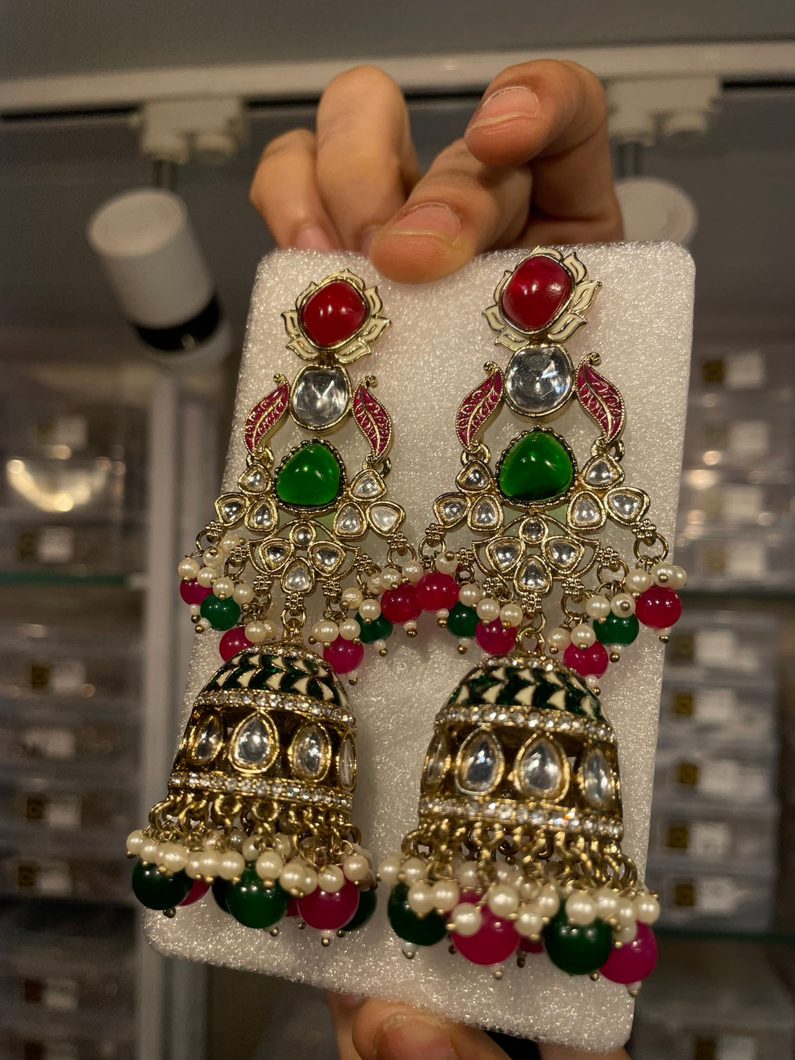Lotus-motif kundan jhumka with red and green enamel detailing