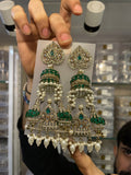 Peacock temple-tiered jhumka with green enamel, pearls and gold detailing