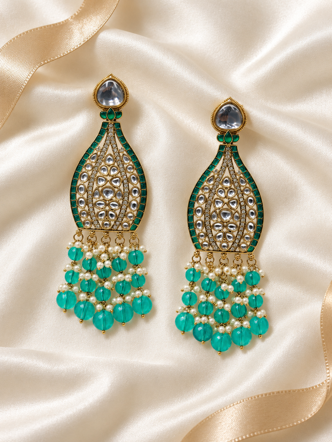 Editorial product-content photo: teal and pearl bridal earrings
