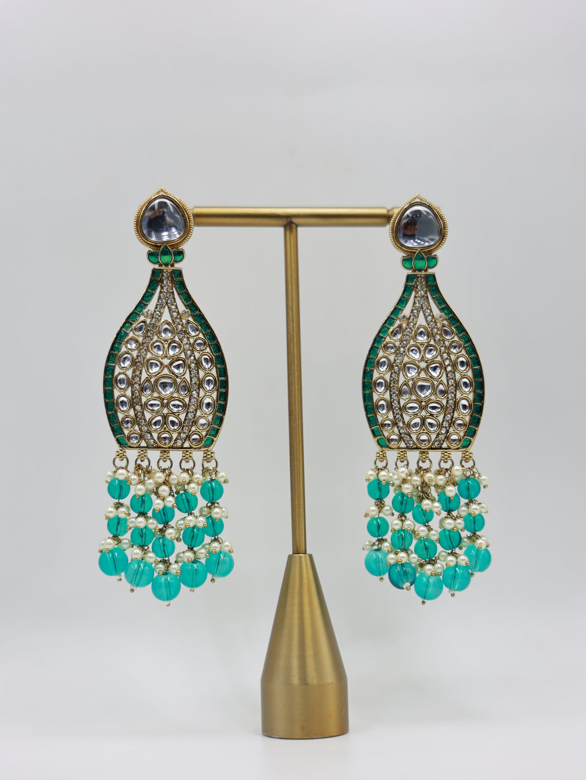 Product displayed on stand: teal and pearl bridal earrings