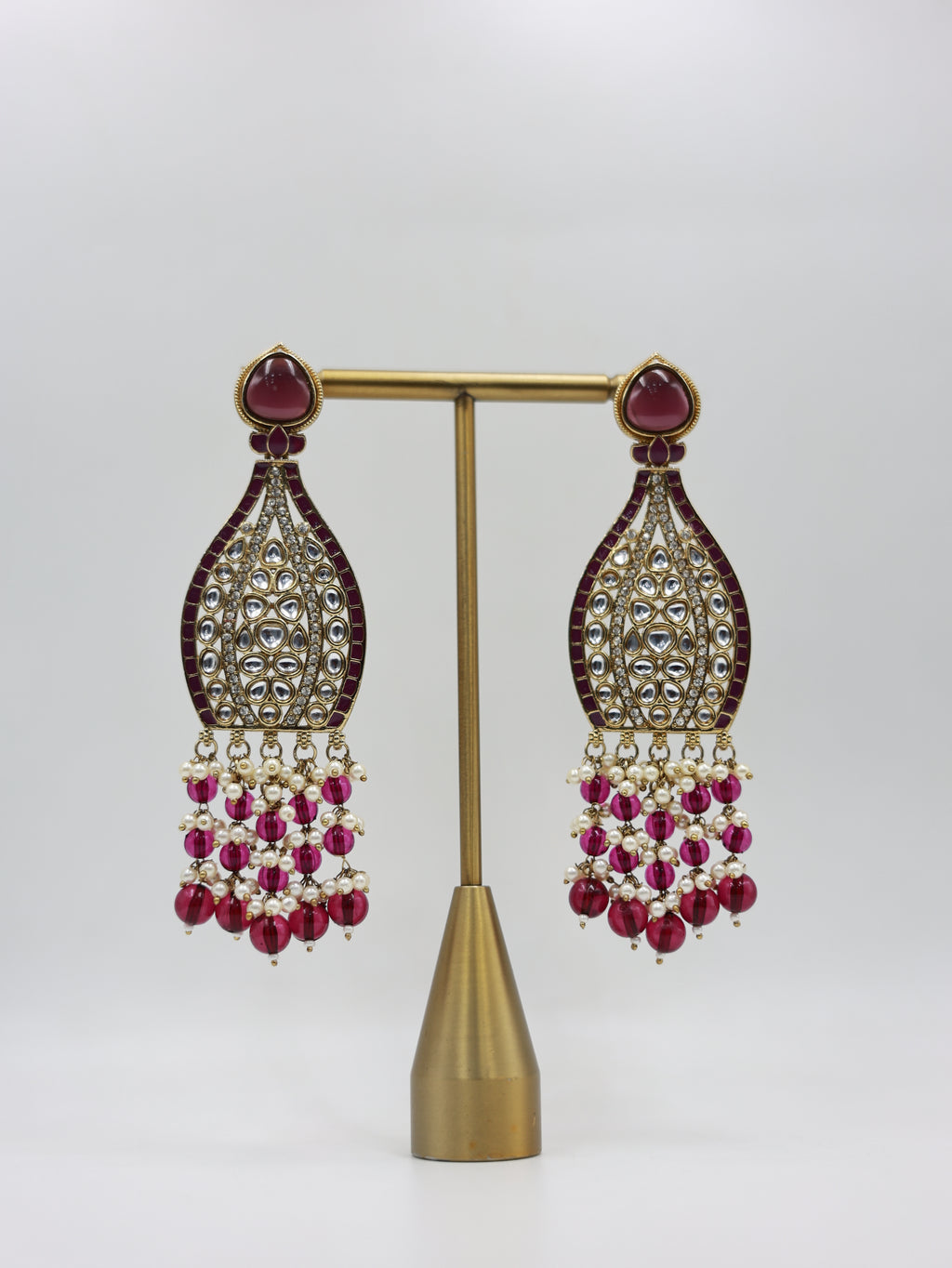Product displayed on stand: magenta and pearl bridal earrings
