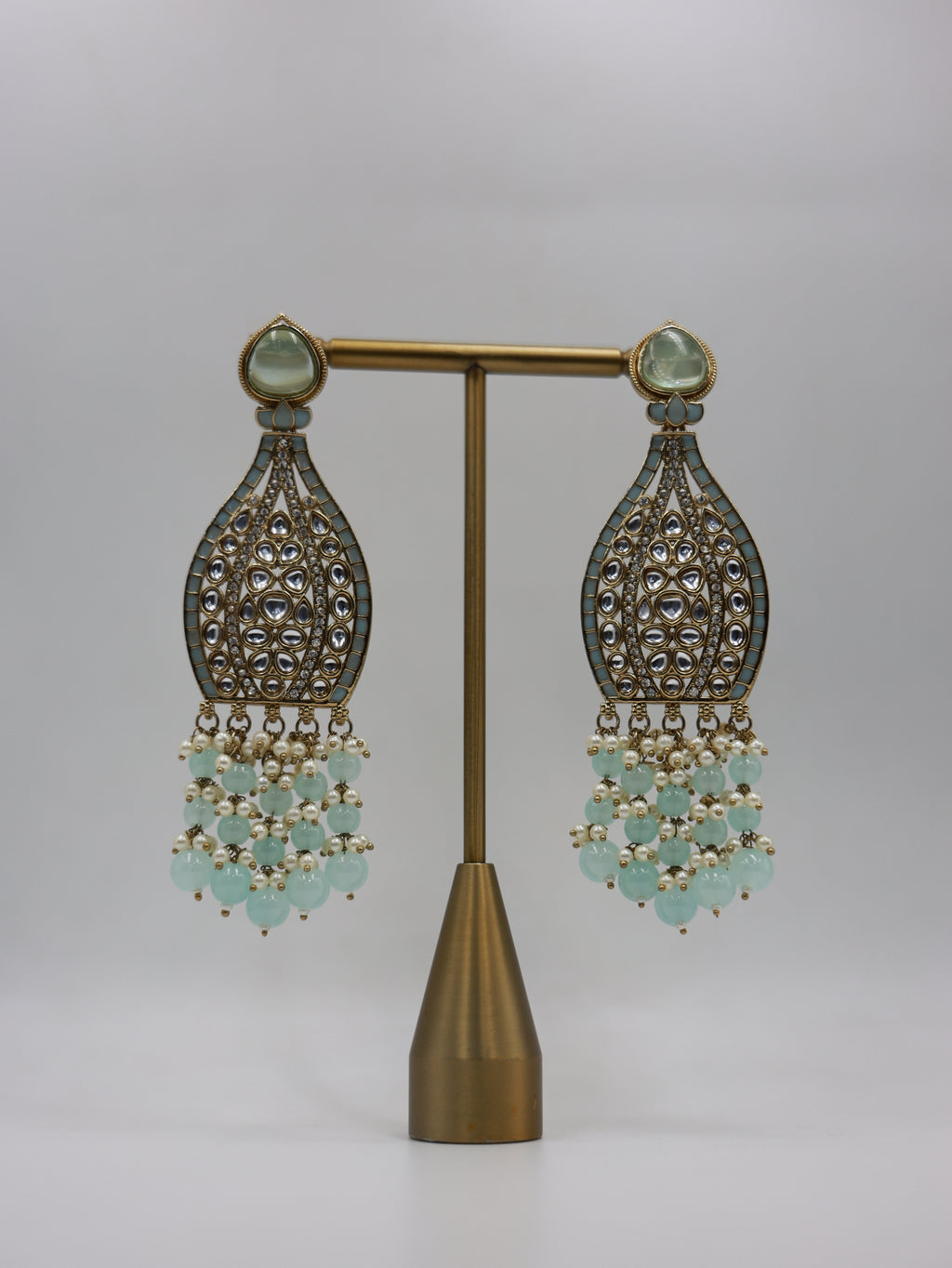 Product displayed on stand: seafoam and pearl bridal earrings