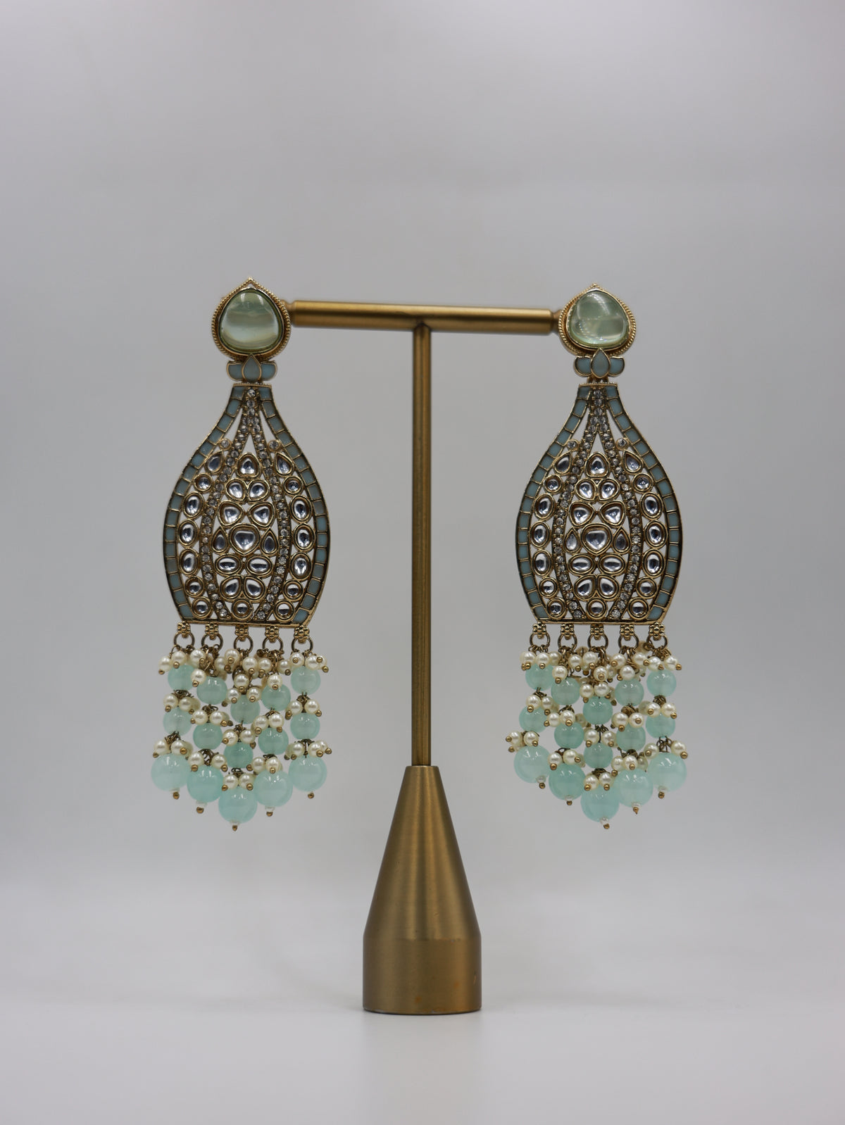 Product displayed on stand: seafoam and pearl bridal earrings
