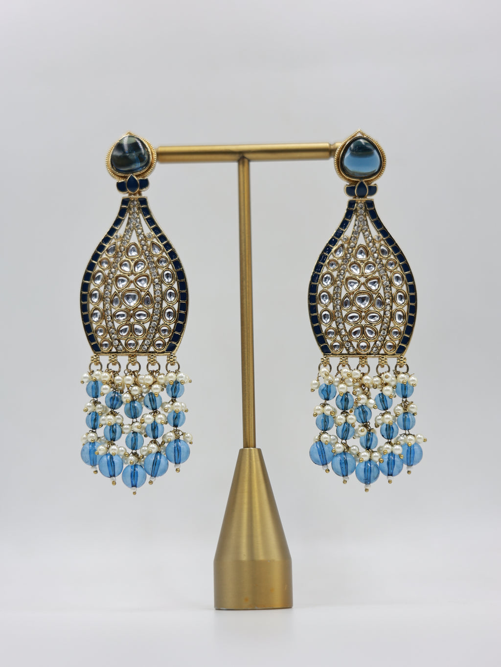 Product displayed on stand: blue and pearl bridal earrings