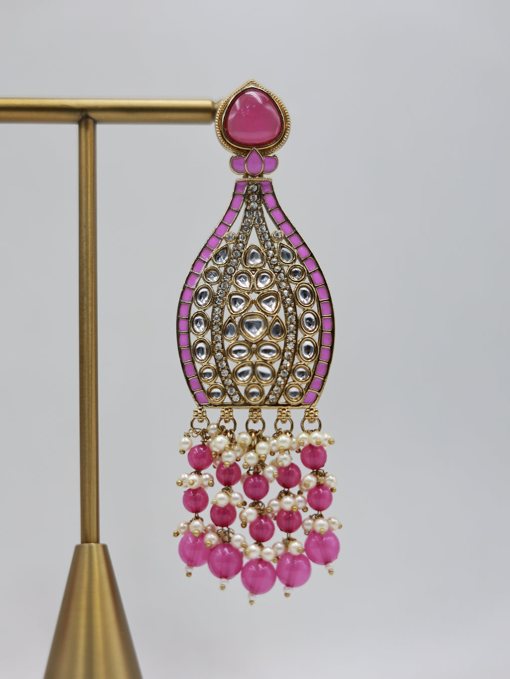 Detailed close-up: pink and pearl bridal earrings