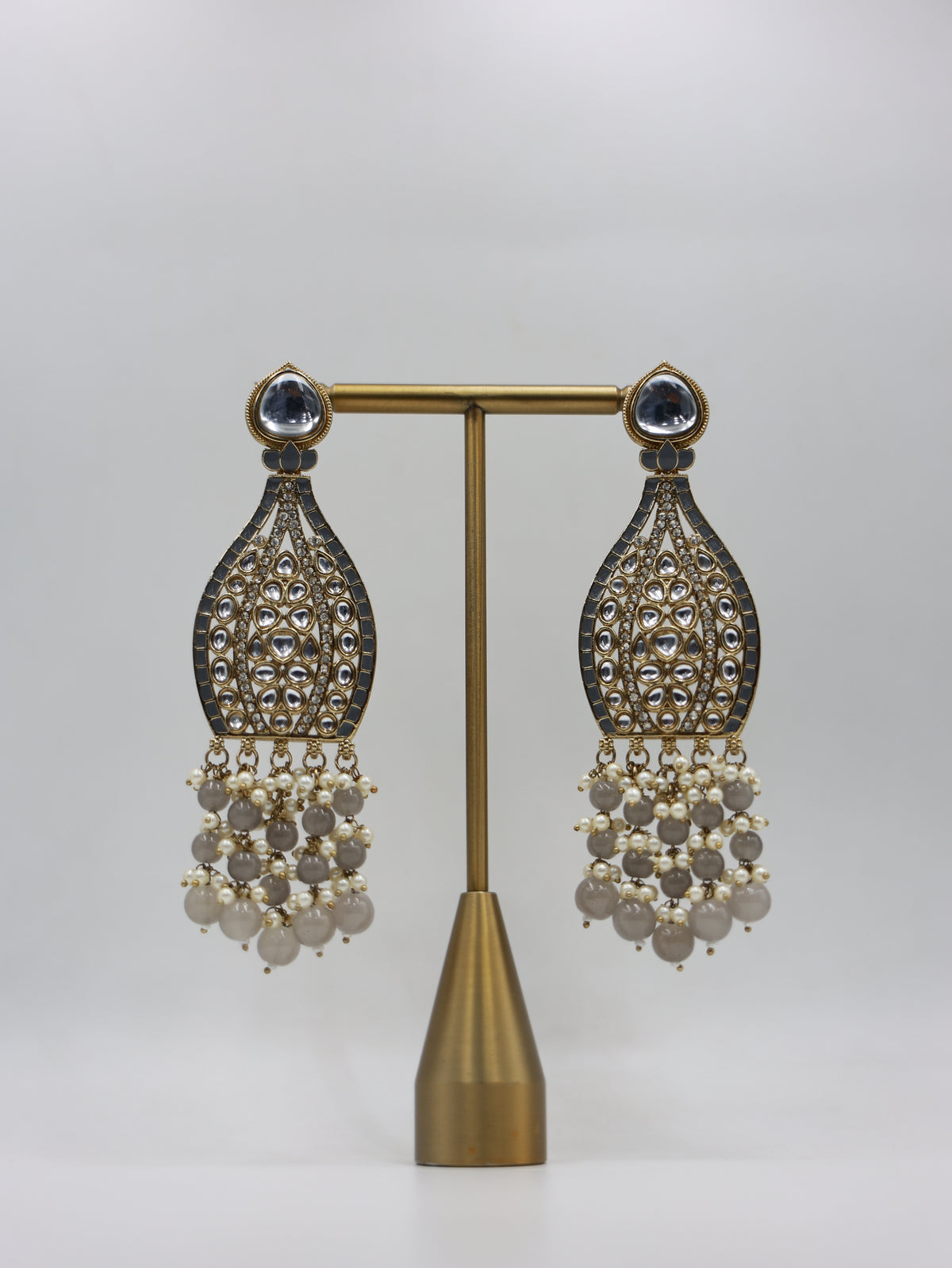 Product displayed on stand: smoky grey and pearl bridal earrings