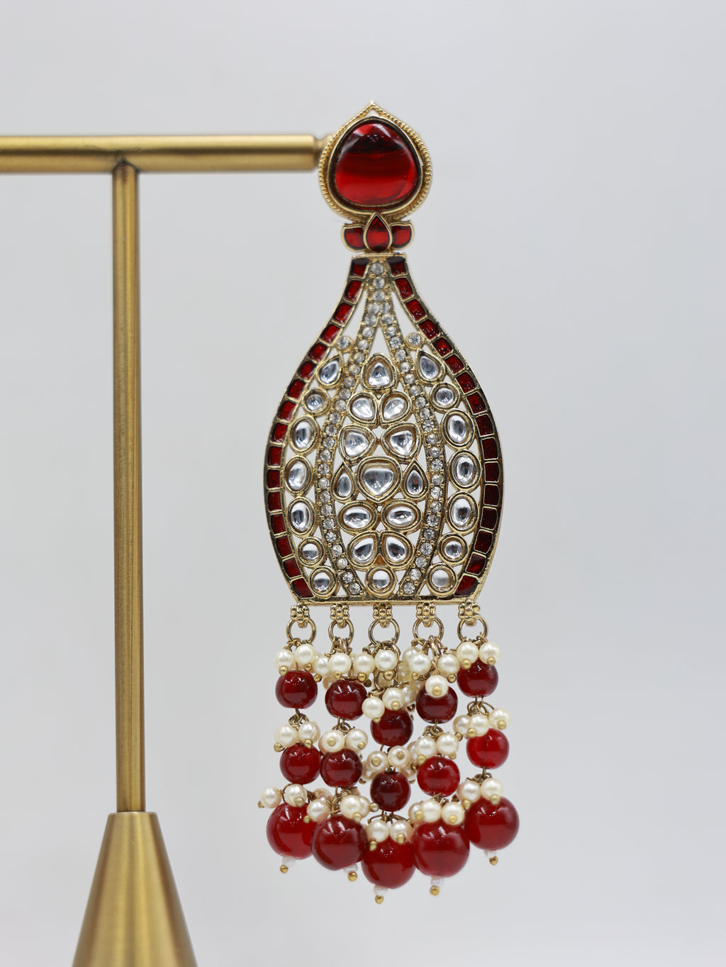 Detailed close-up: ruby and pearl bridal earrings