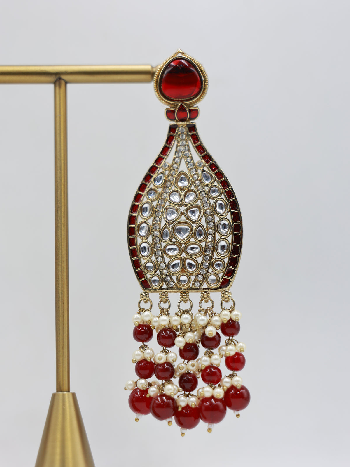 Detailed close-up: ruby and pearl bridal earrings